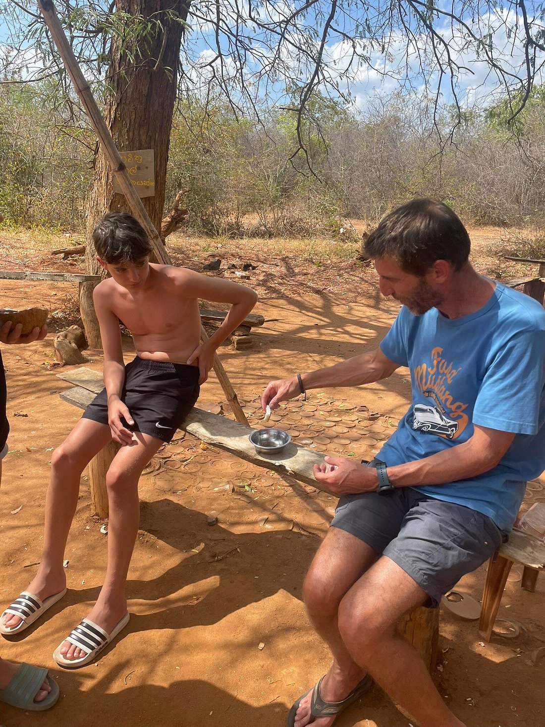 Traveller and a local boy at a village stop in rural Sri Lanka